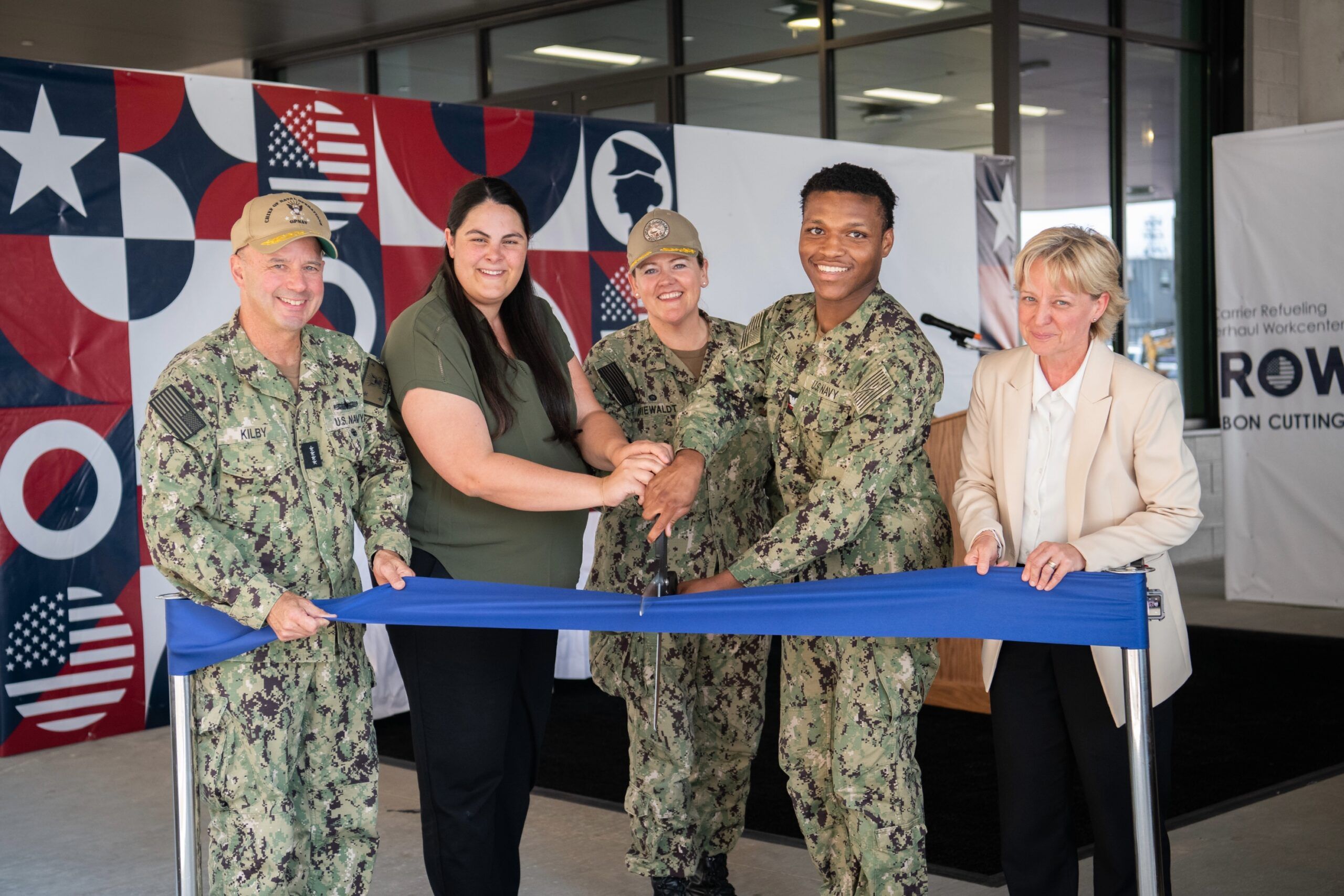 SUPSHIP Newport News Commanding Officer Capt. Hannah Kriewaldt, Newport News Shipbuilding President Kari Wilkinson, Vice Chief of Naval Operations Adm. Jim Kilby, HII-NNS employee Ashley Martin, and CVN 74 “Bluejacket of the Year” EM3 Dashon McNeal cut the ceremonial ribbon to the Carrier Refueling Overhaul Workcenter on June 25, 2026.